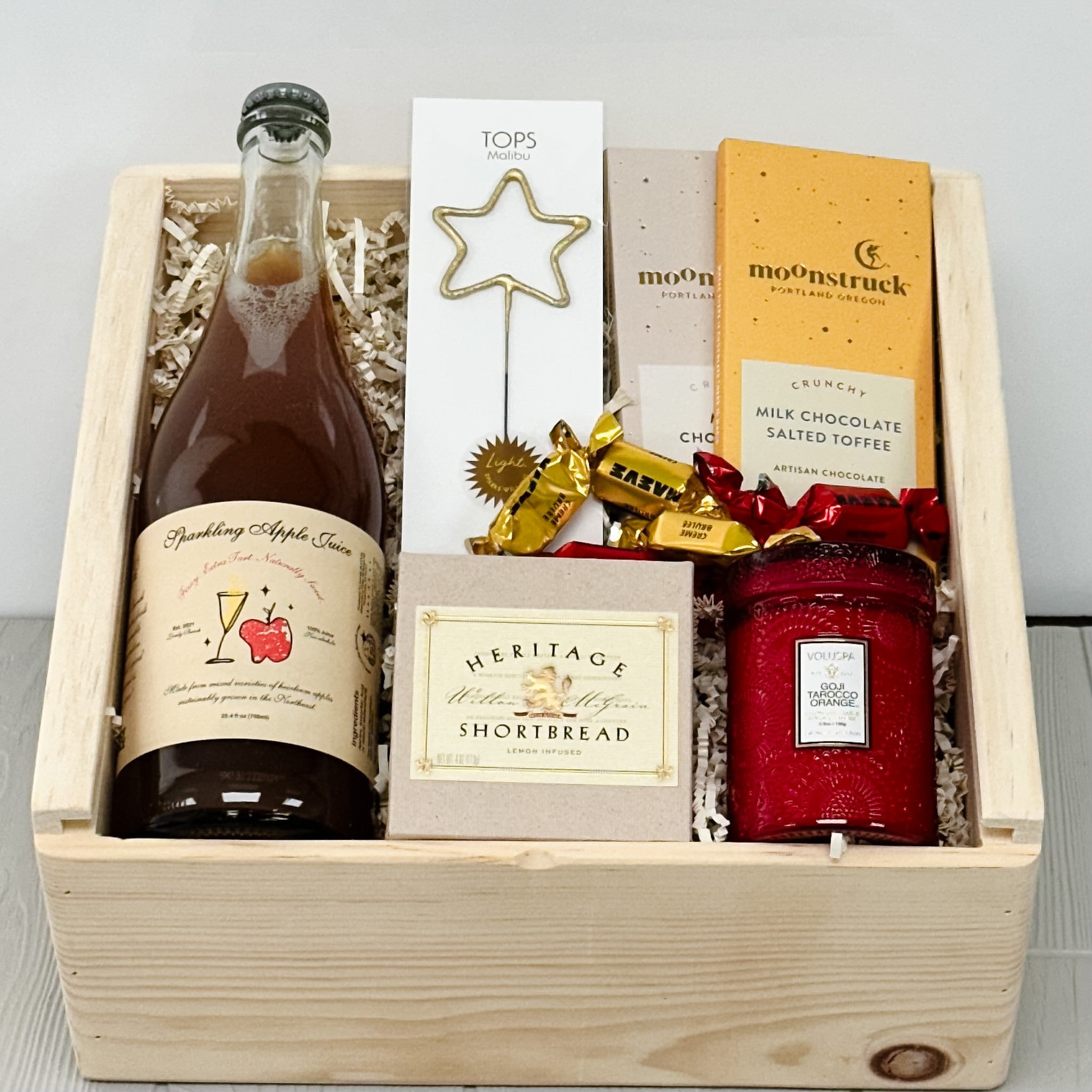 sparkling apple juice, chocolate, shortbread, candle, sparkler all included in our cheers non-alcoholic gift basket.