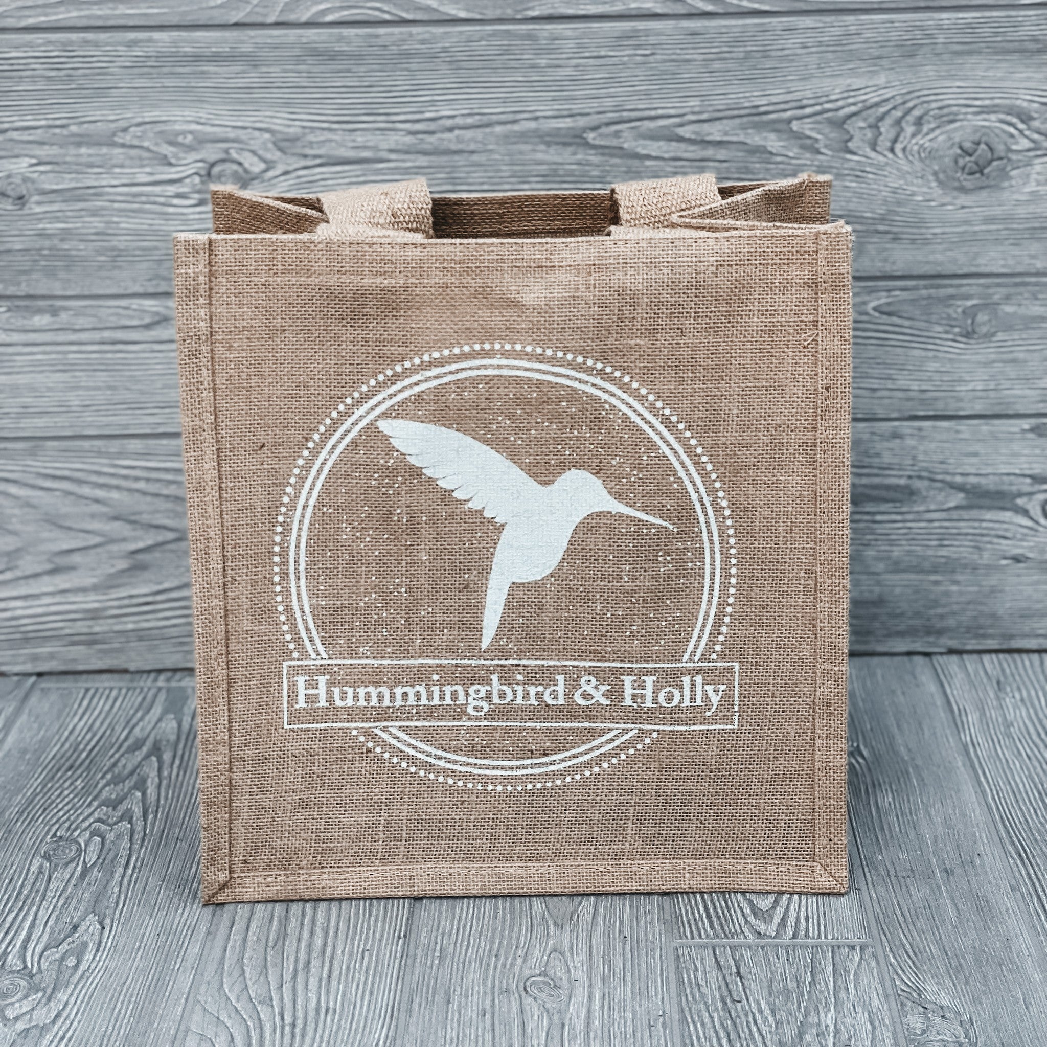 Natural jute tote with a Hummingbird and Holly logo