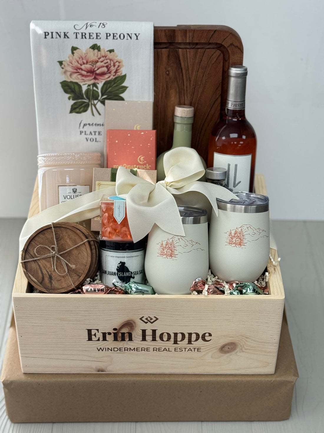 gift box including a cutting board, coasters, wine tumblers, snacks, wine, and olive oil, packaged in a custom wooden crate