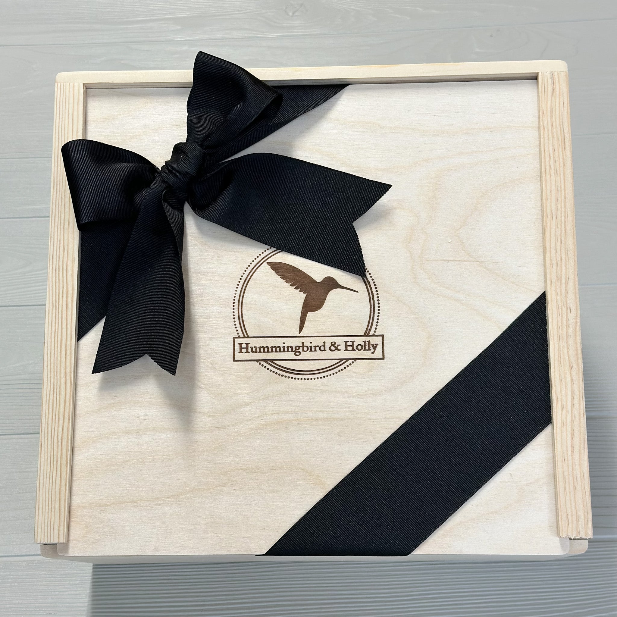 close up of our locally made wooden slide lid gift box included in our sip and sparkle gift basket