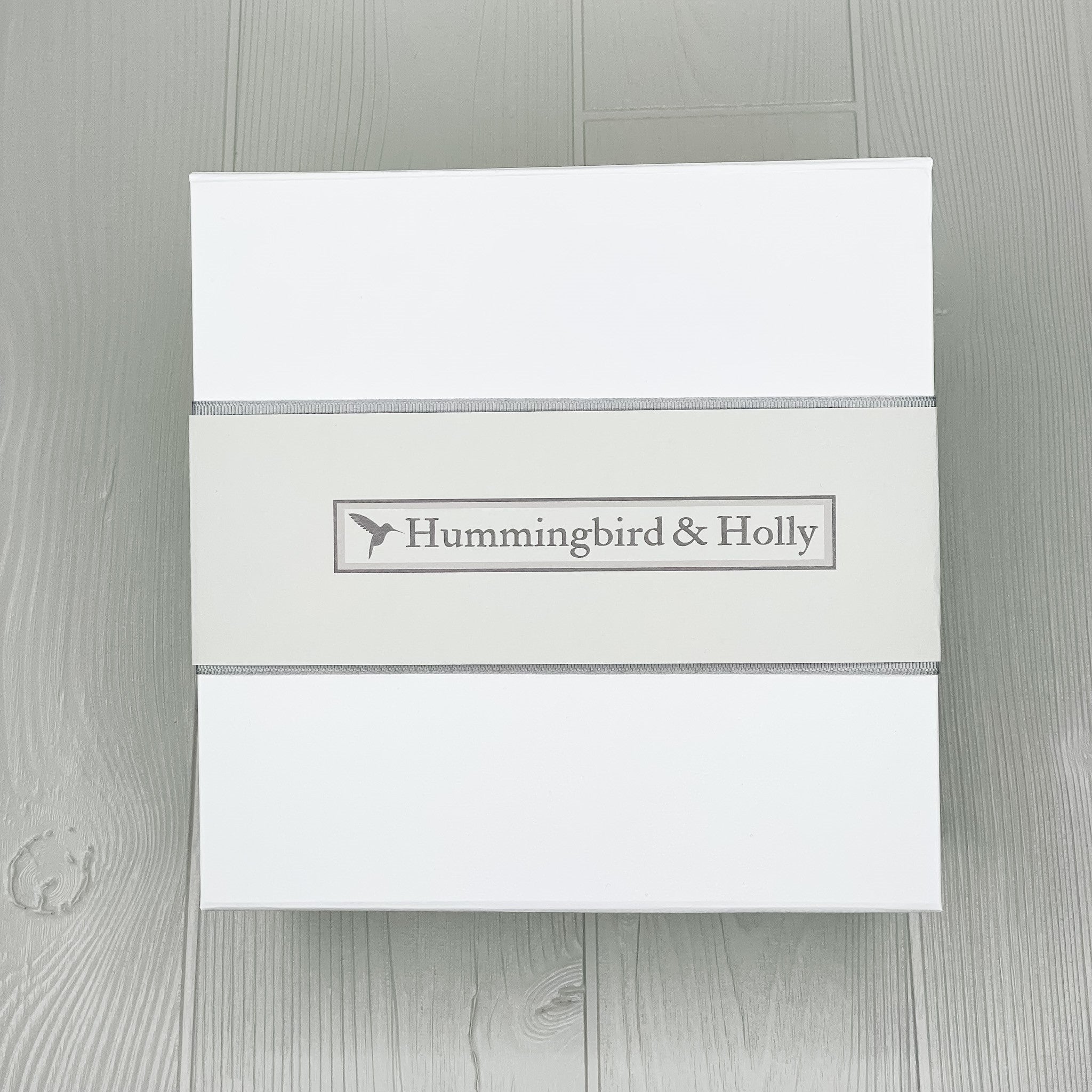 gift box with Hummingbird and Holly logo