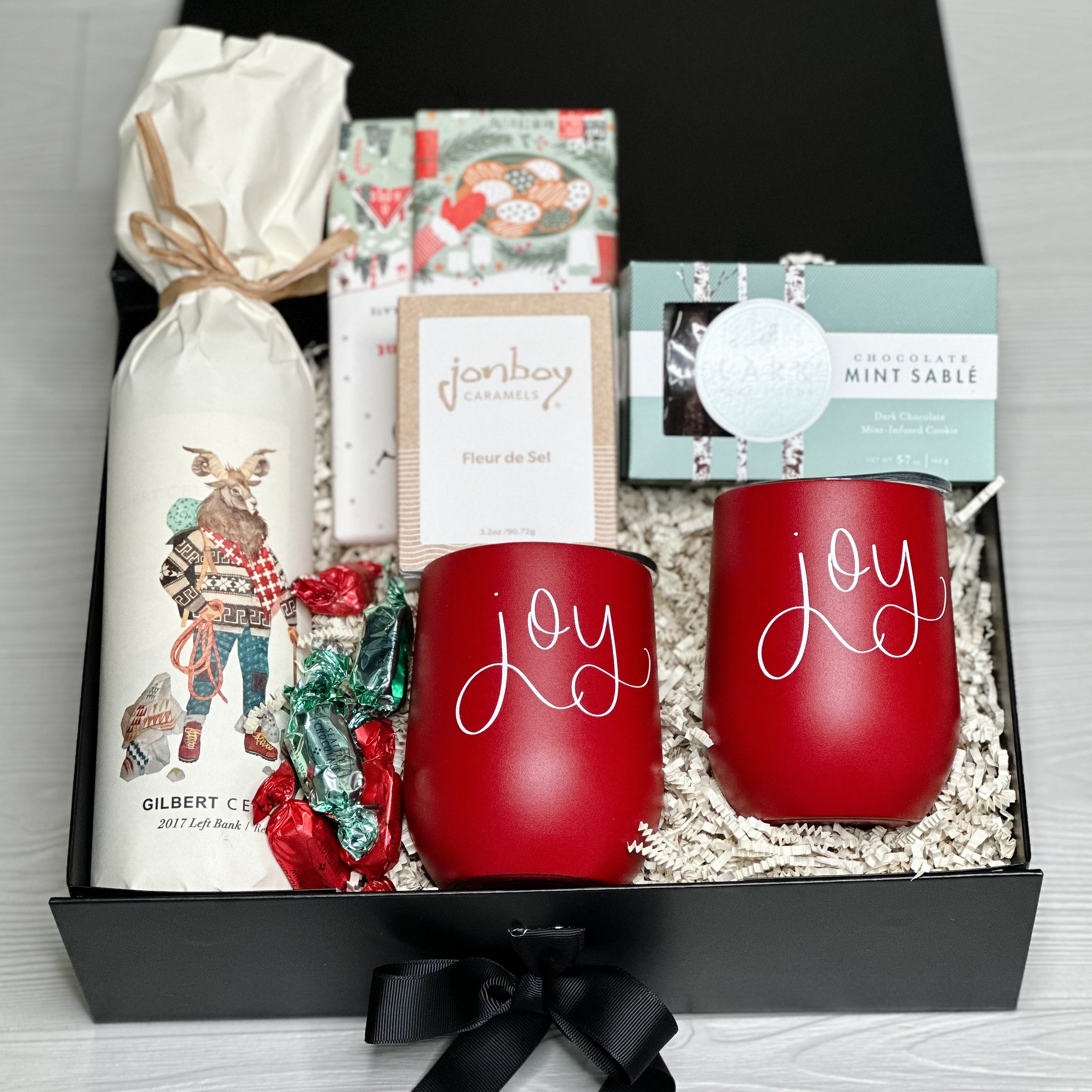 Red wine, chocolate, caramel, cookie and 2 wine tumblers all a part of our eat drink and be joyful gift basket