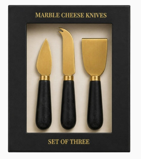 close up of black and gold cheese knives.
