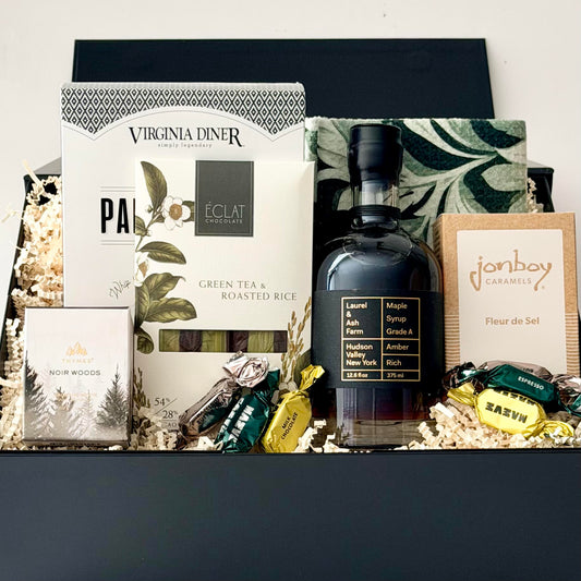 pancake mix, syrup, dish towel, chocolate, caramel, and noir woods candle by thymes.