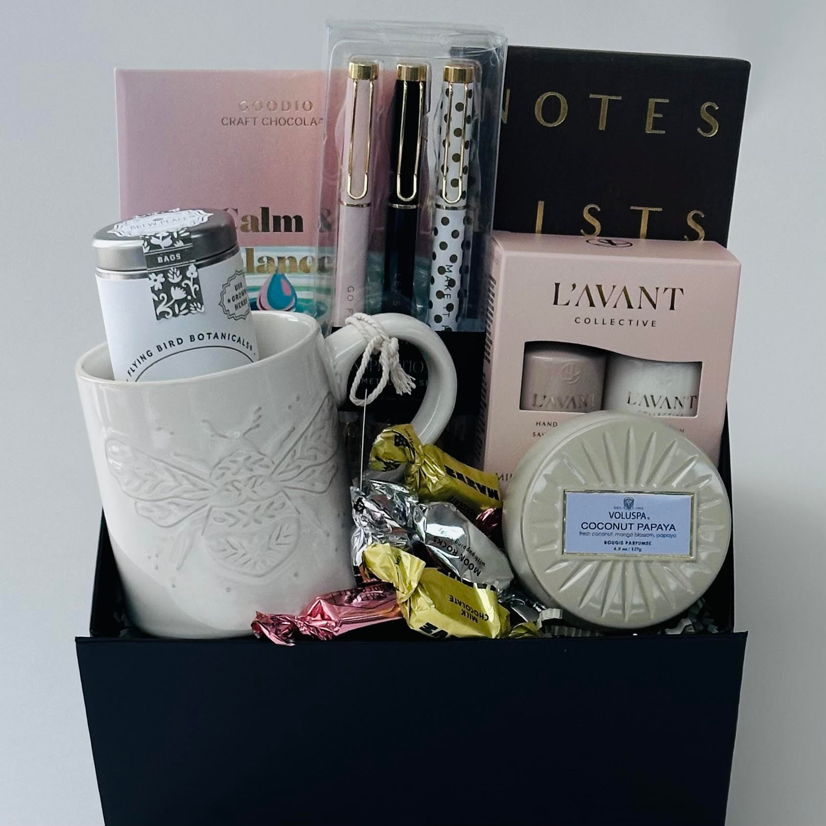 bumble bee mug, tea, chocolate, pens, notebook, candle, hand cream set all packaged in our black gift box. 