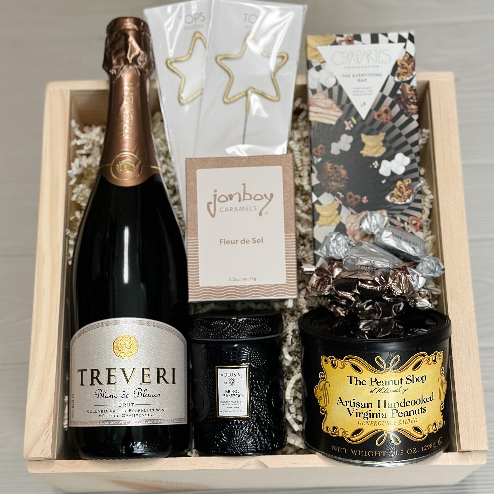 champagne, sparklers, chocolate, caramel, scented candle, peanuts included in our celebrate gift basket