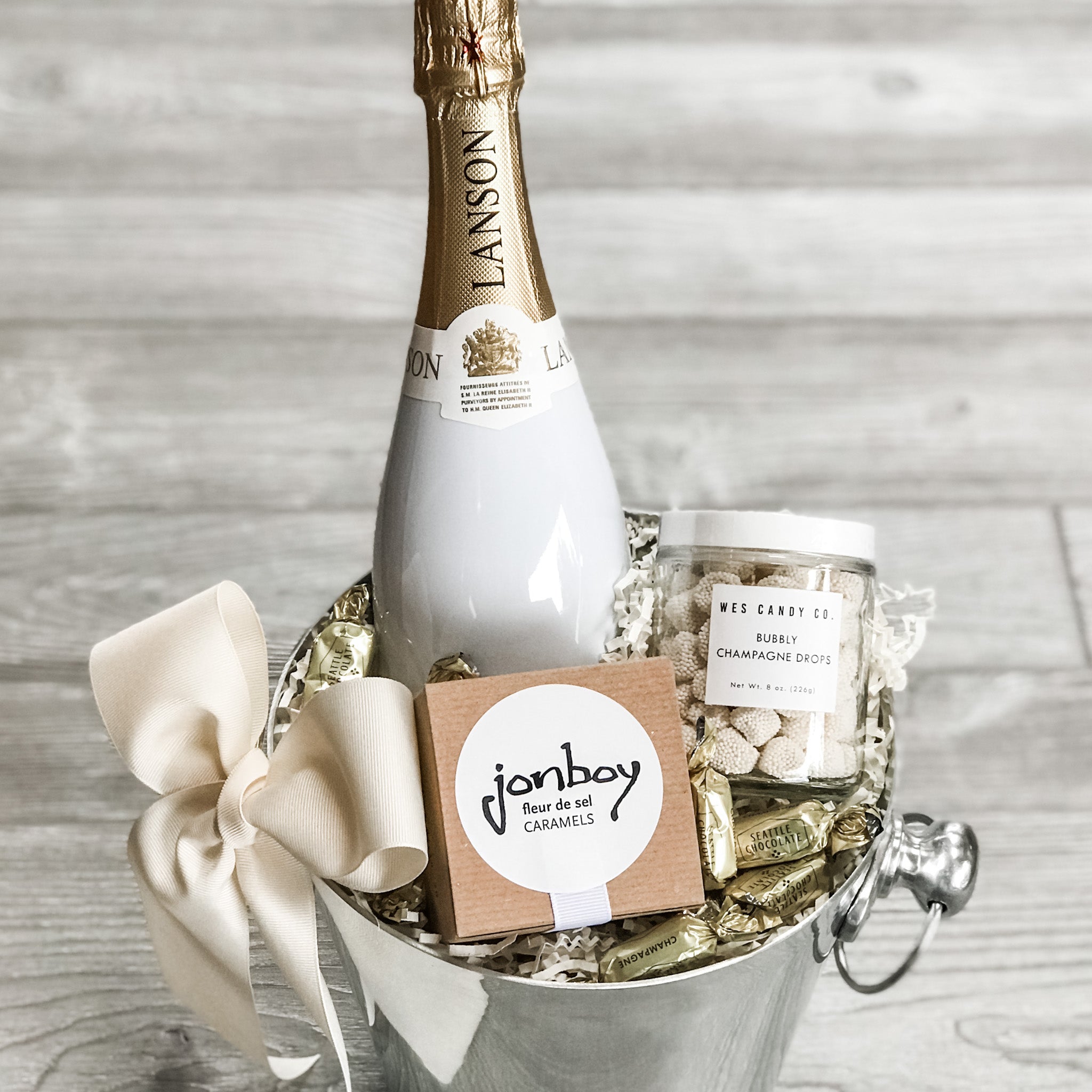wedding gift basket that includes Lanson champagne, caramel, gummy bears, chocolate, ice bucket