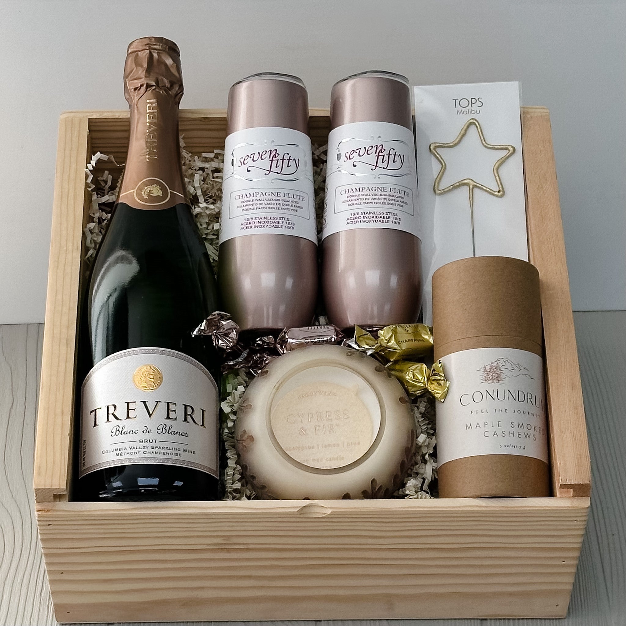 champagne, flutes, cashews, candle truffles gold star sparkler included in our cheers gift basket