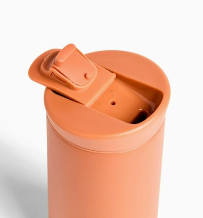 Close up of terracotta traveler mug.