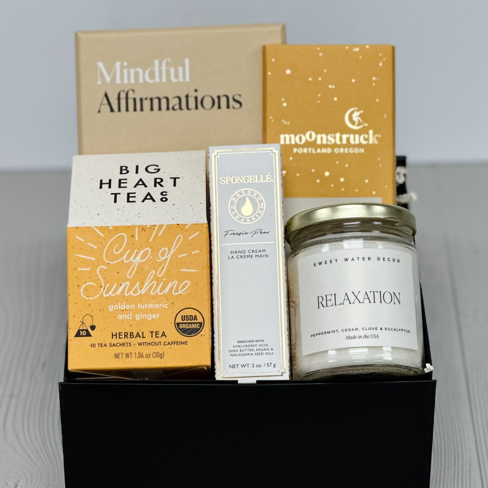 mindful affirmation cards, tea, chocolate, candle, lotion included in our cup of sunshine gift basket