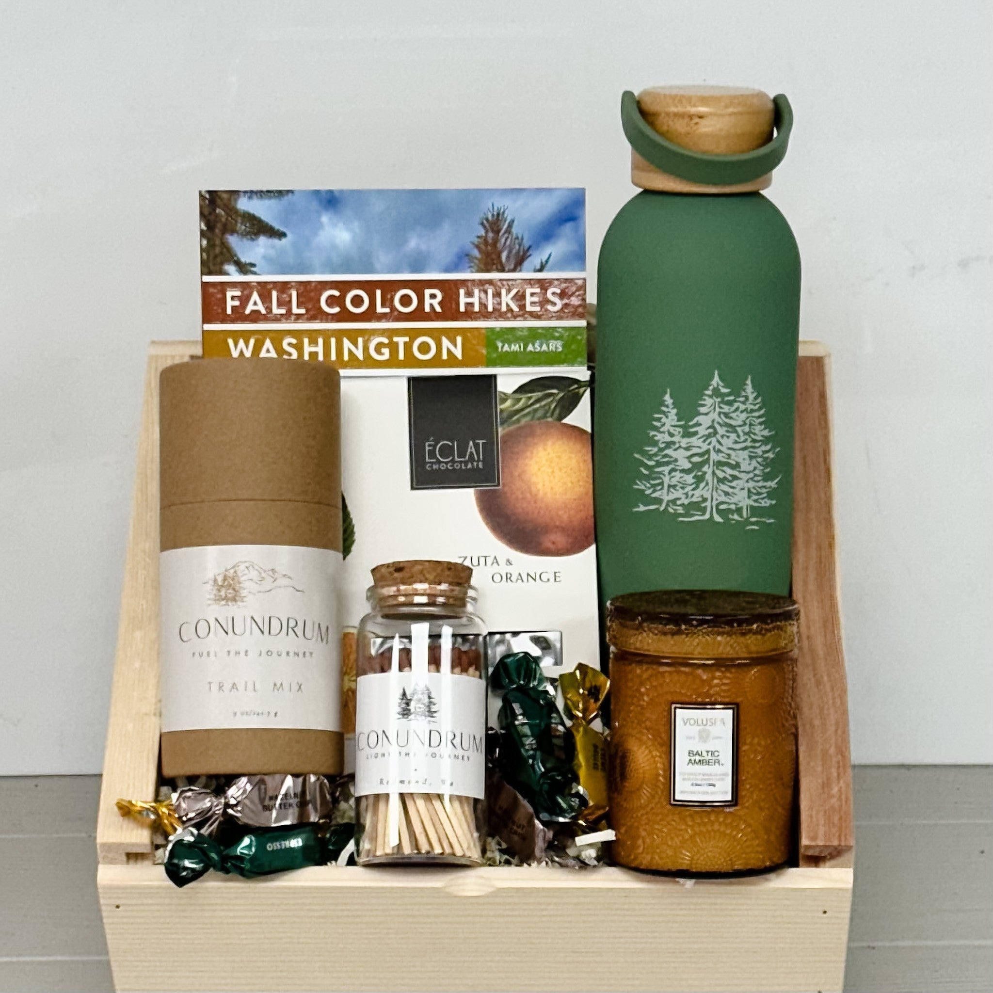 fall hiking book, water bottle, chocolate trail mix, candle, matches all included in our PNW Autumn Hikes gift basket.