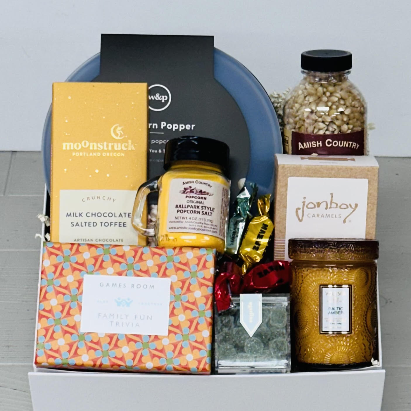 Popcorn popping bowl, popcorn, seasoning, game, chocolate, candle included in a gift box.