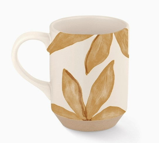 close up of coffee mug with brown leaves.