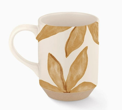 close up of coffee mug with brown leaves.