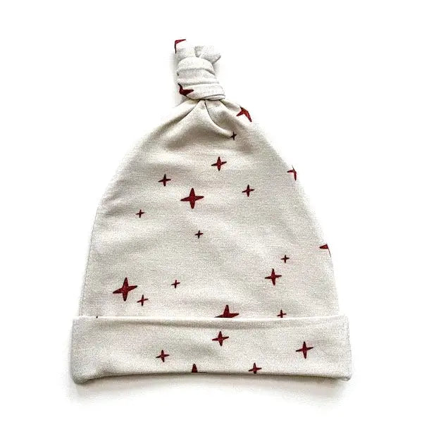Close up of knotted baby hat with brown stars.