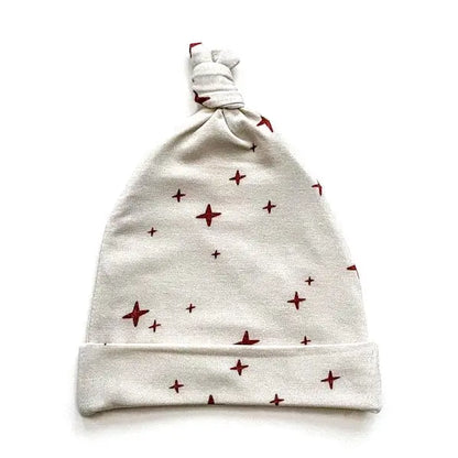Close up of knotted baby hat with brown stars.