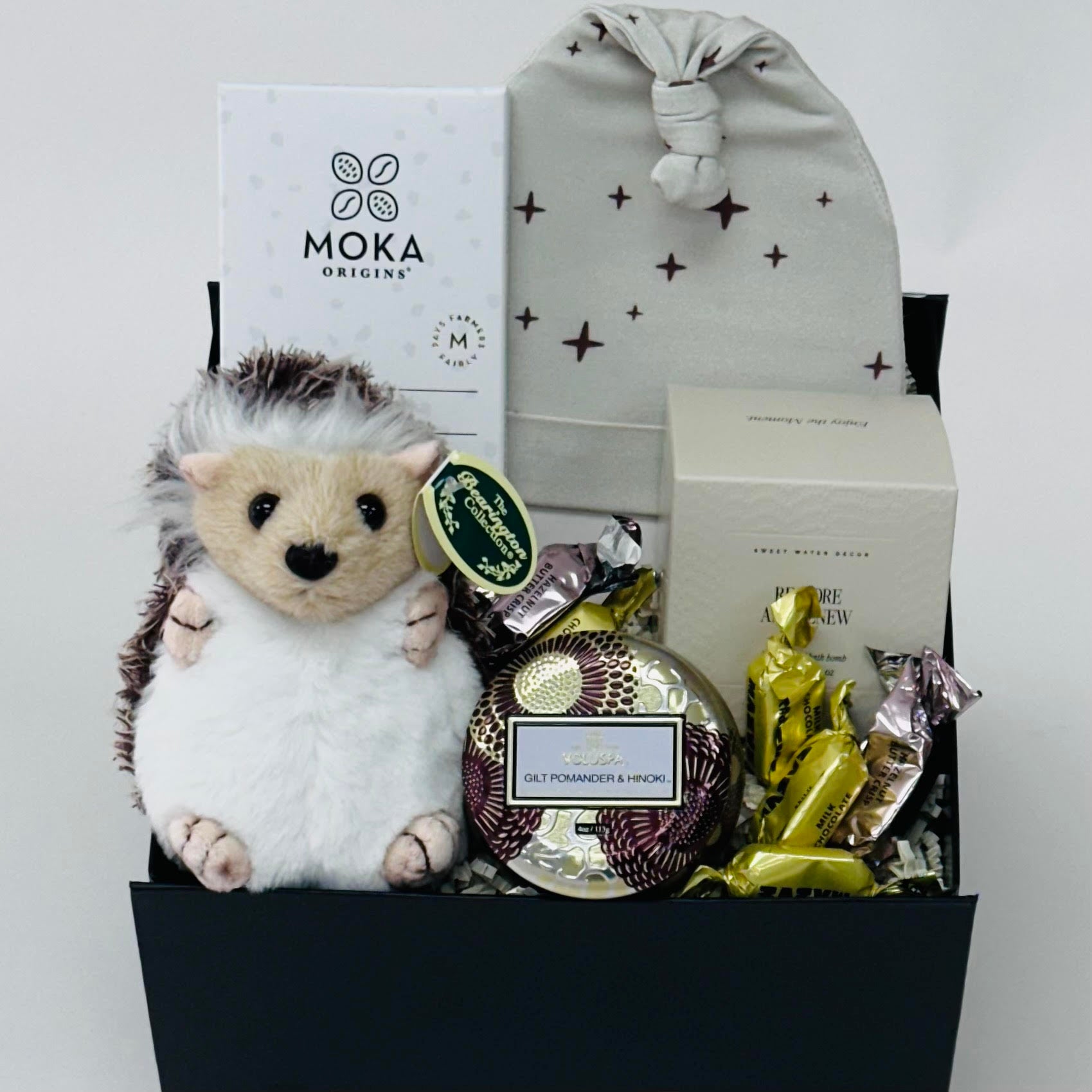 beanie, hedgehog, chocolate, bath bomb, candle all included in our gift box.