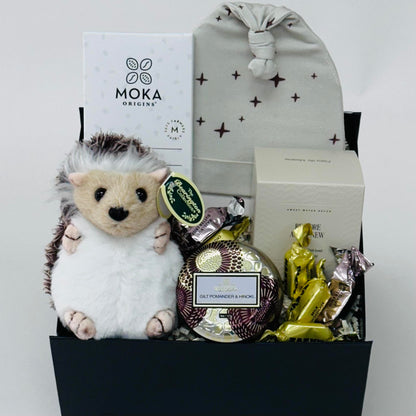beanie, hedgehog, chocolate, bath bomb, candle all included in our gift box.