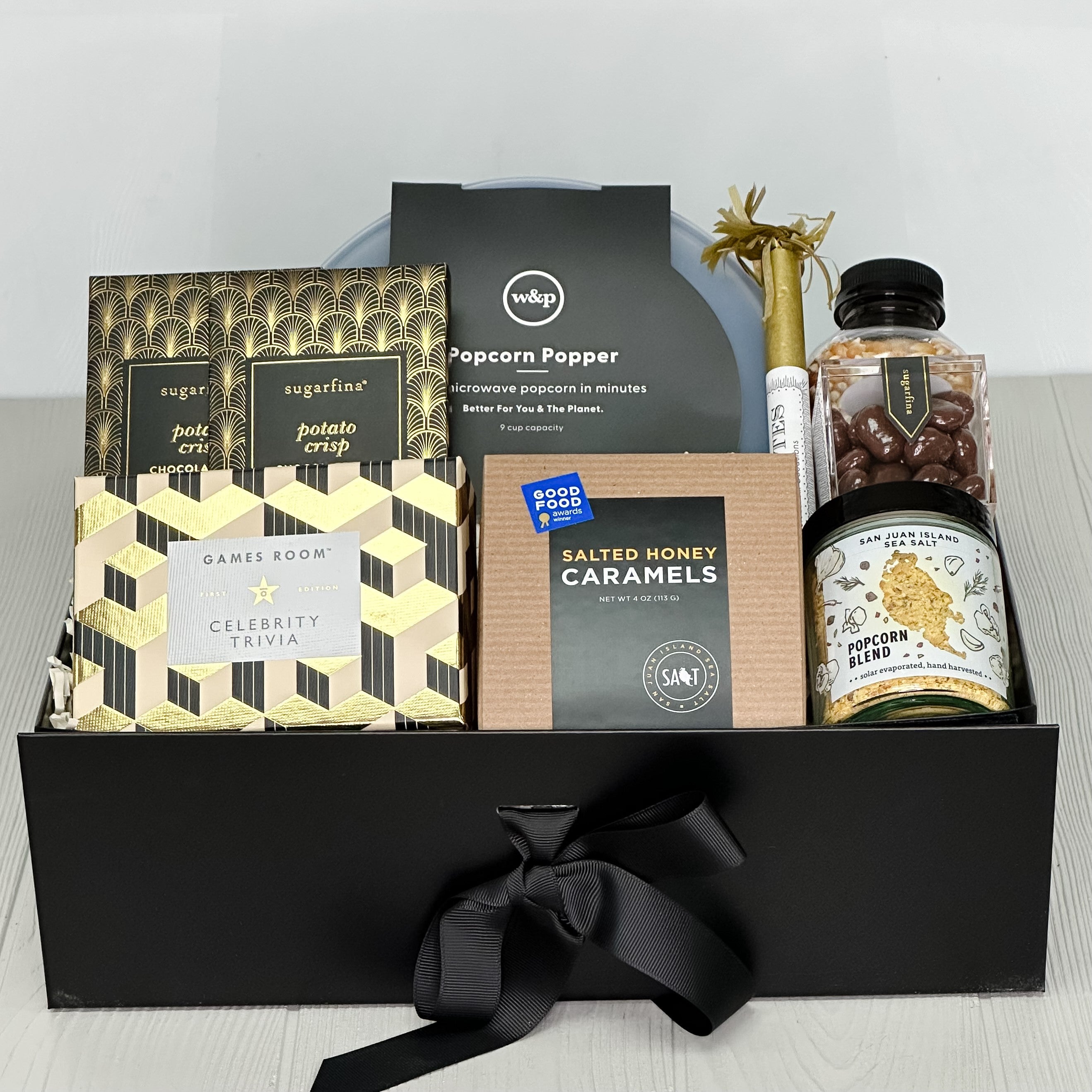 popcorn popper, popcorn, popcorn seasoning salt, caramel, chocolate pecans, game, chocolate bars all included in our Elegant Holiday Game Night gift basket