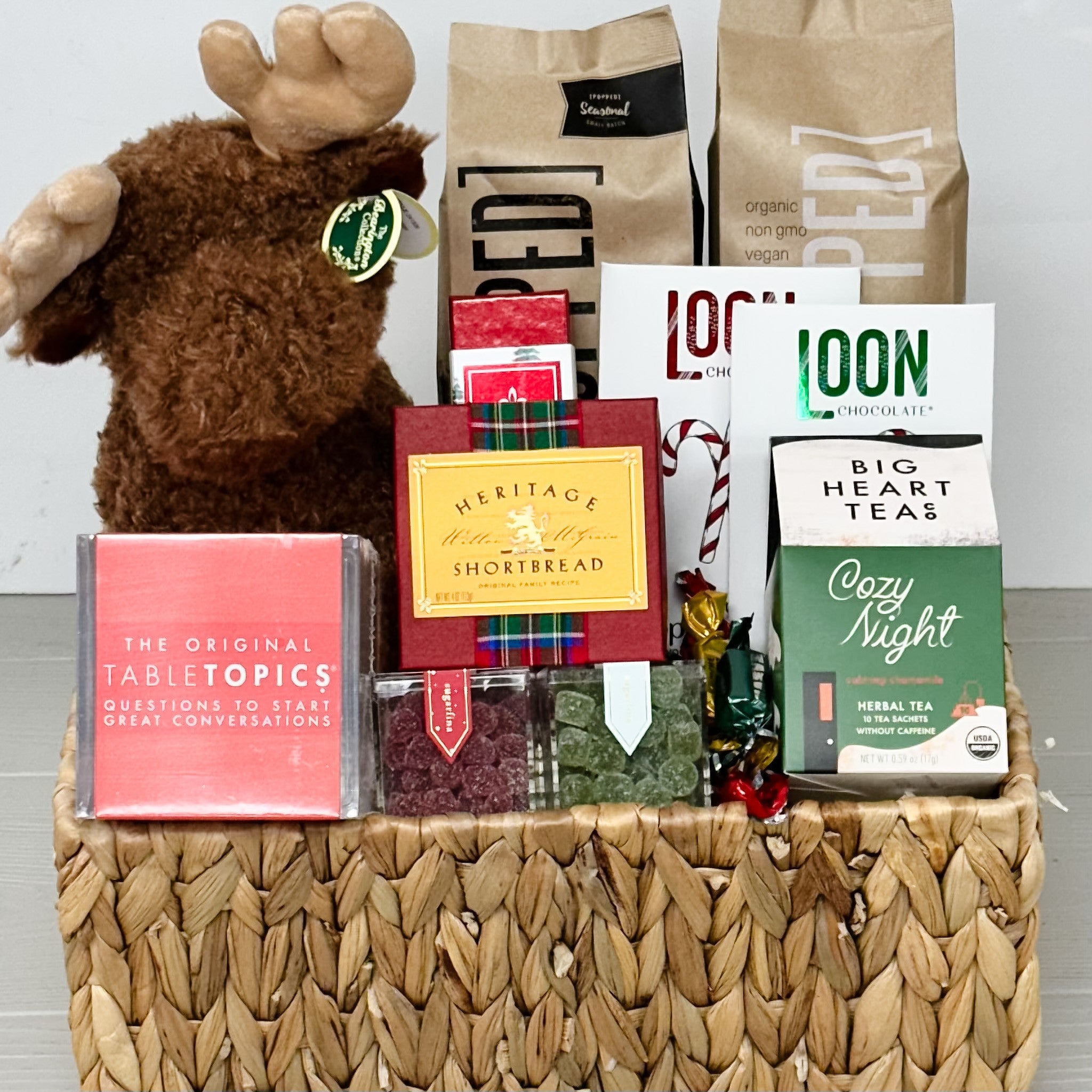 moose, tabletopics, popcorn, chocolate, caramel, shortbread, candy, tea, truffles all included in our pnw winter family gift basket