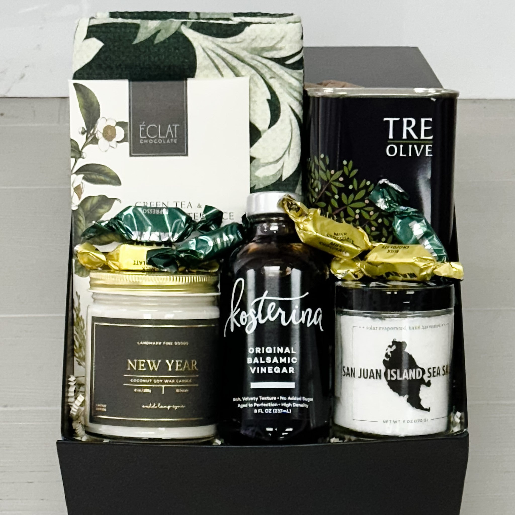 tea towel, olive oil, sea salt, new years candle, balsamic vinegar, truffles, chocolate all included in our holiday kitchen gift basket.