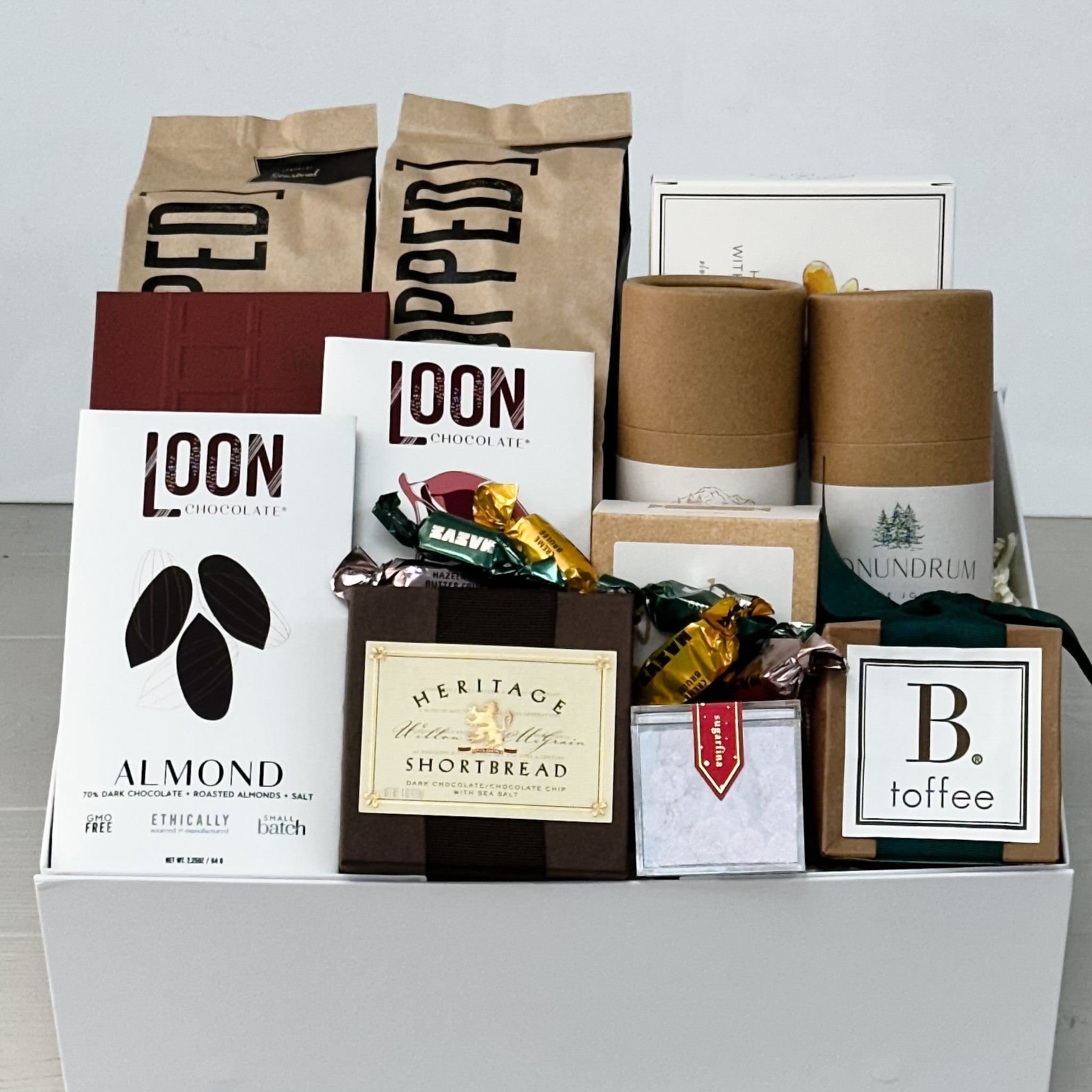 popcorn potato chips, cashews, yogurt pretzels, toffee, caramel, candy, shortbread and chocolate all included in our large winter treats gift basket.