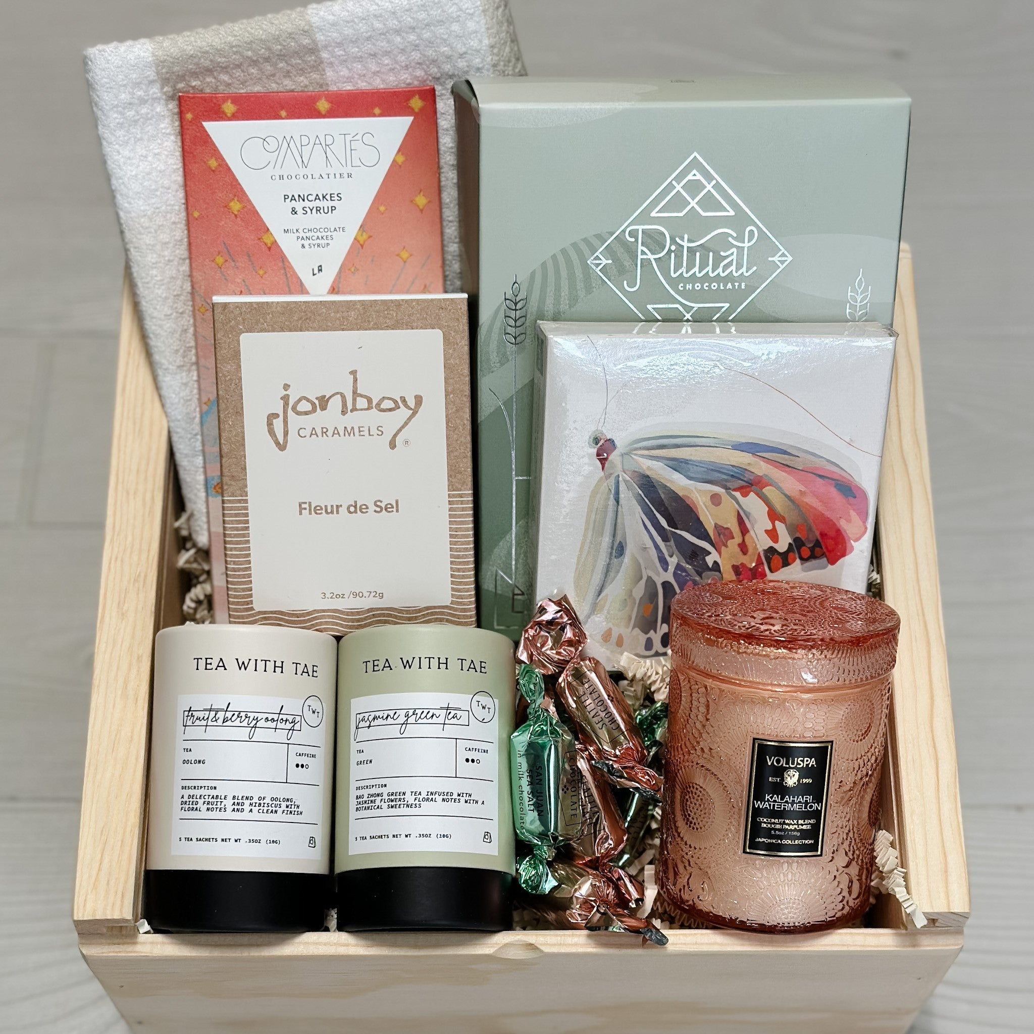 Granola, dish towel, chocolate, caramel, tea, candle and matches all included in our Let's Brunch gift basket