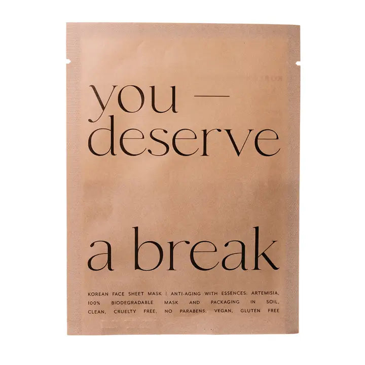 Korean face sheet mask packaging with text 'you deserve a break' on a beige background