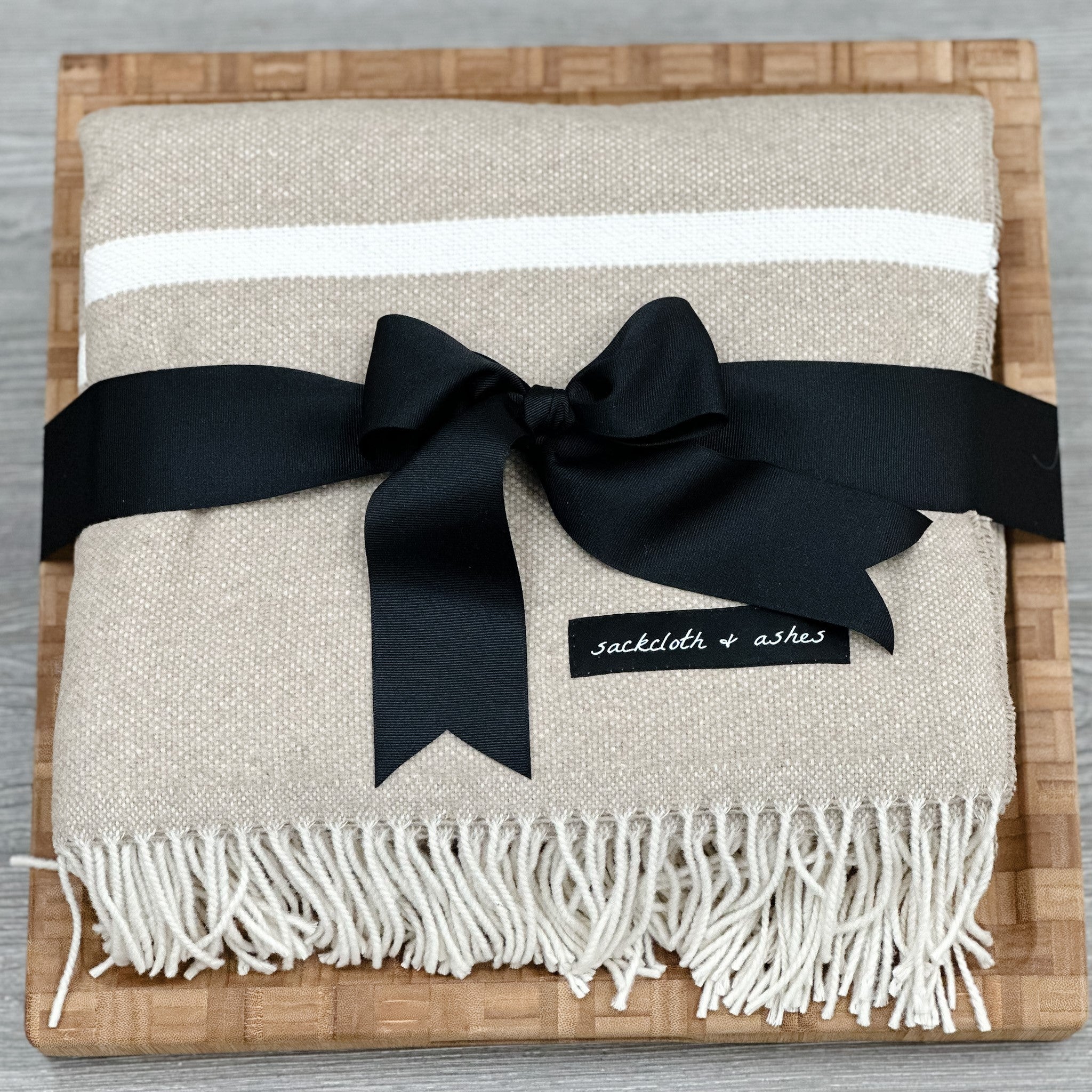 large butcher block and luxury throw blanket included in our luxury housewarming gift basket
