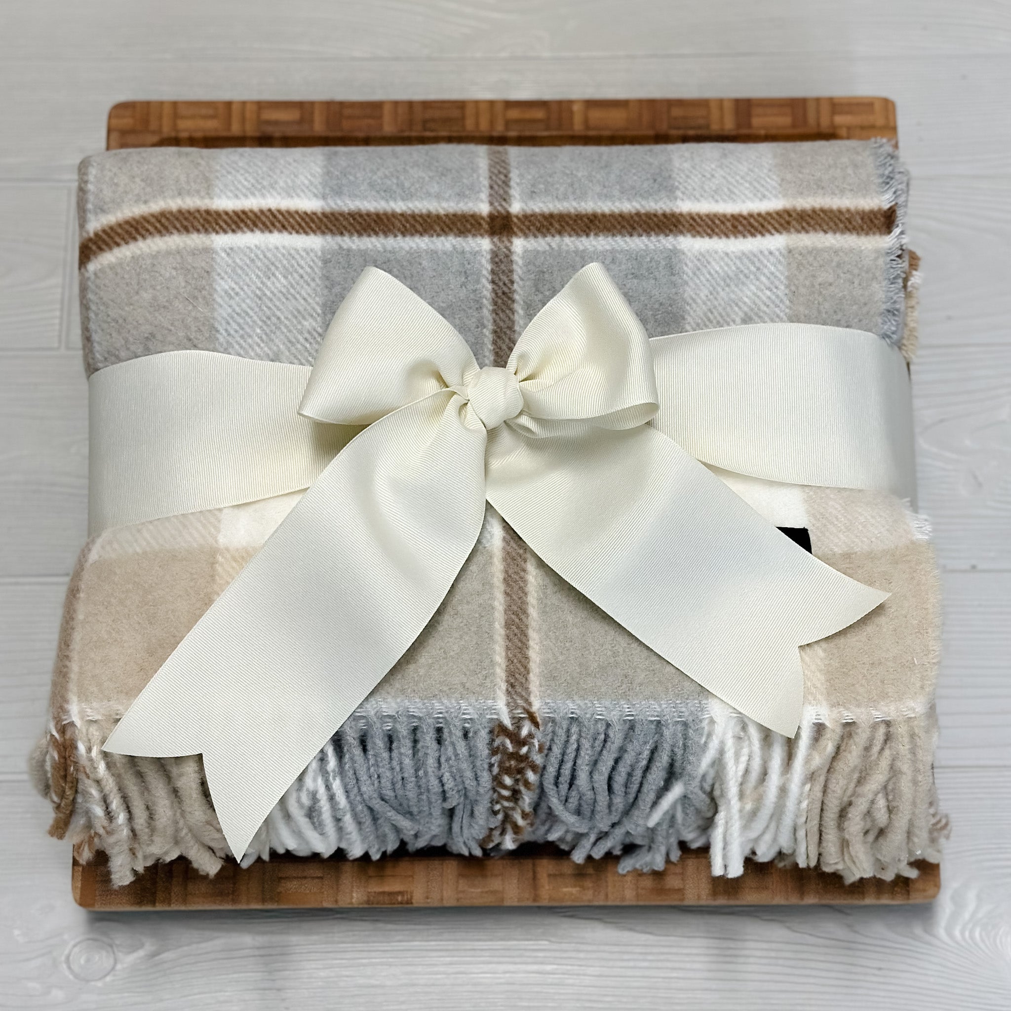 large wooden cutting board, luxury blanket included in our luxury housewarming gift basket