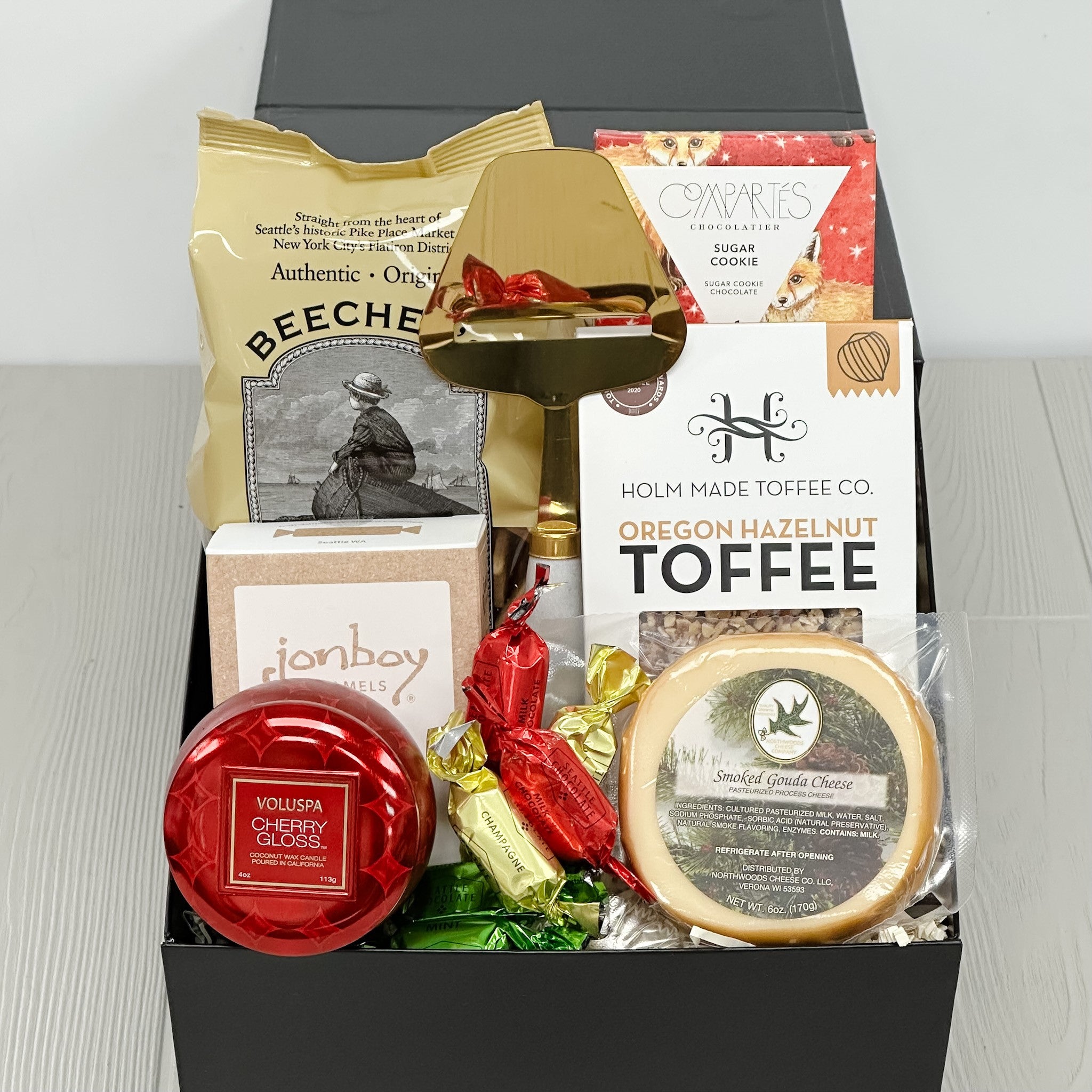 crackers, cheese, chocolate, toffee, caramel, cheese slicer, truffles all included in our mini cheers & charcuterie gift basket.