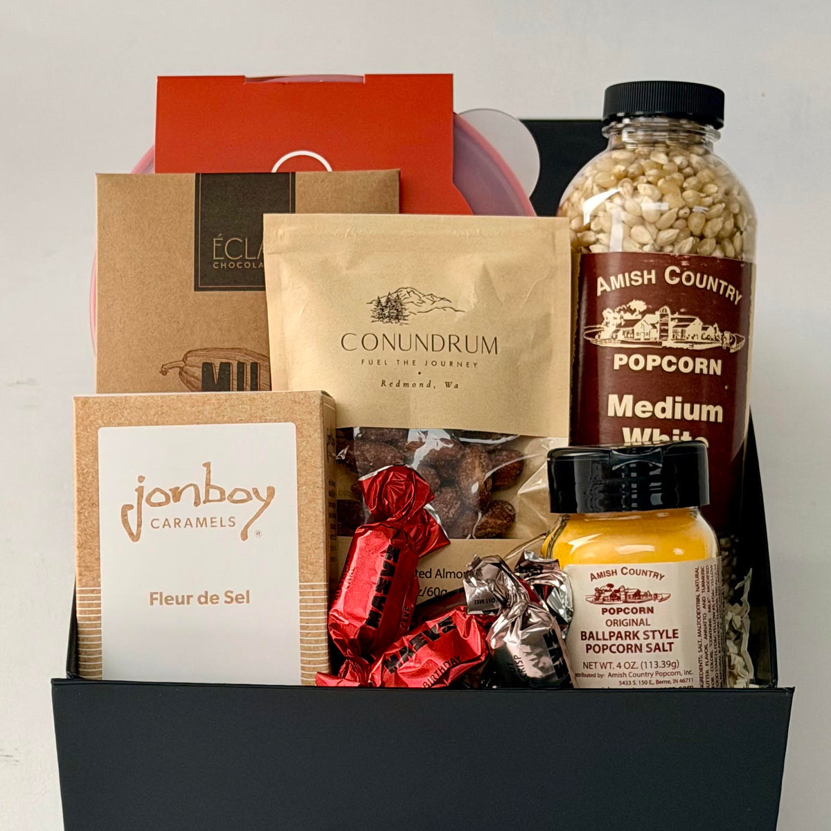 gift box with personal popcorn popper, popcorn, salt, chocolate, caramel, nuts.