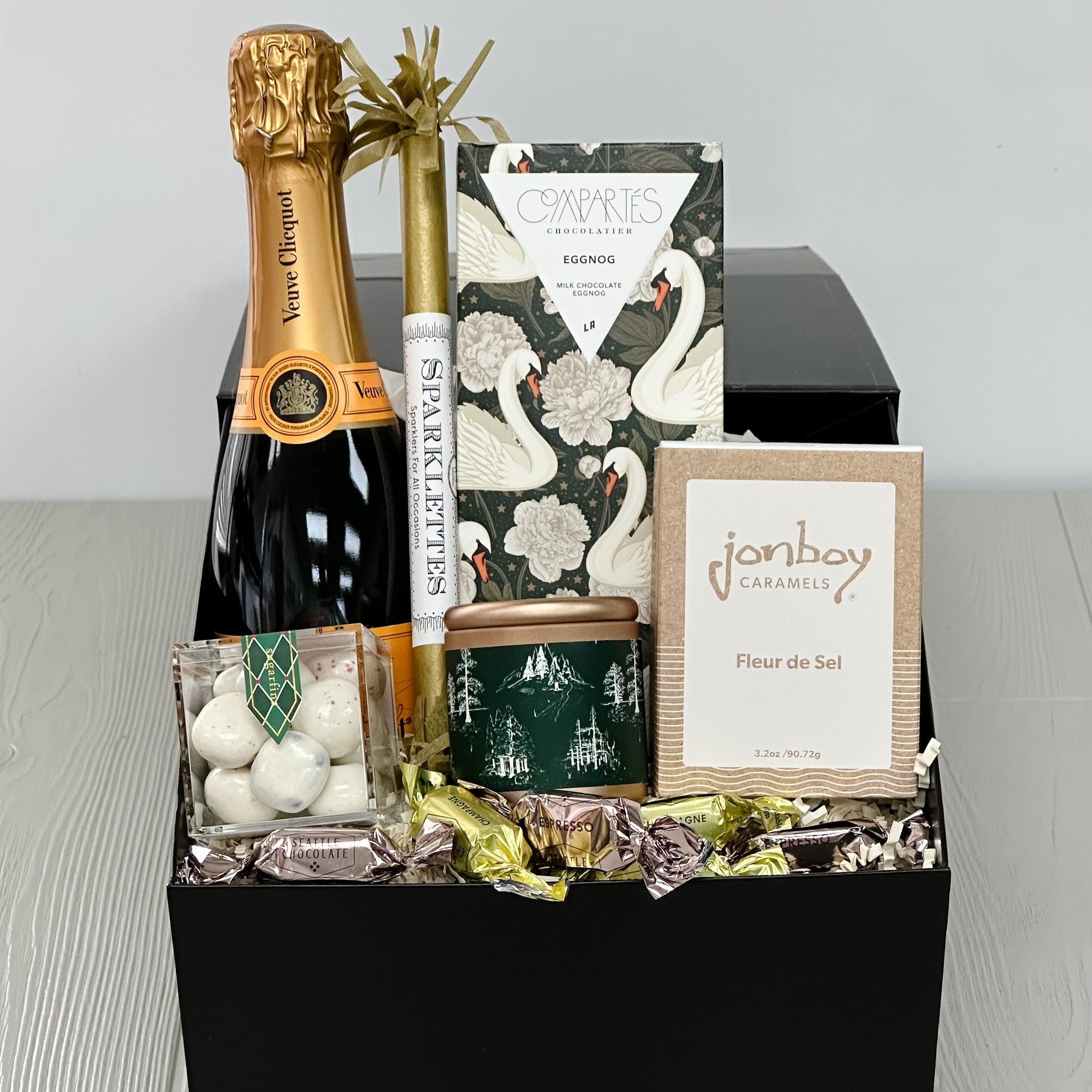 champagne sparkler, chocolate, candle, caramel, candy, truffles all included in our sweet & sparkling gift basket