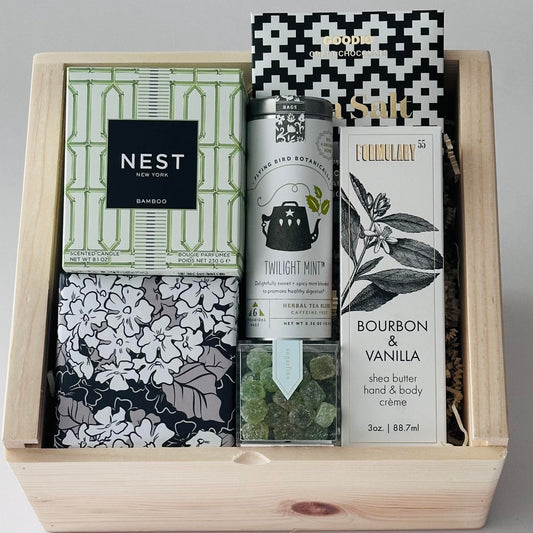 gift box includes a luxury candle, tea, chocolate, tea, candy and lotion.