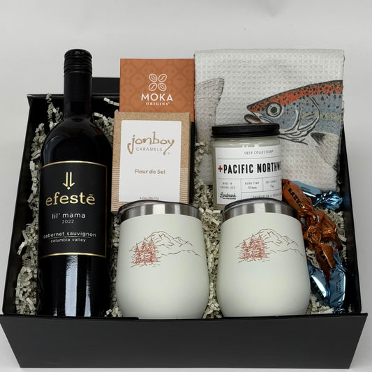 gift box with wine, wine tumblers, tea towel, chocolate, candle and caramel. 