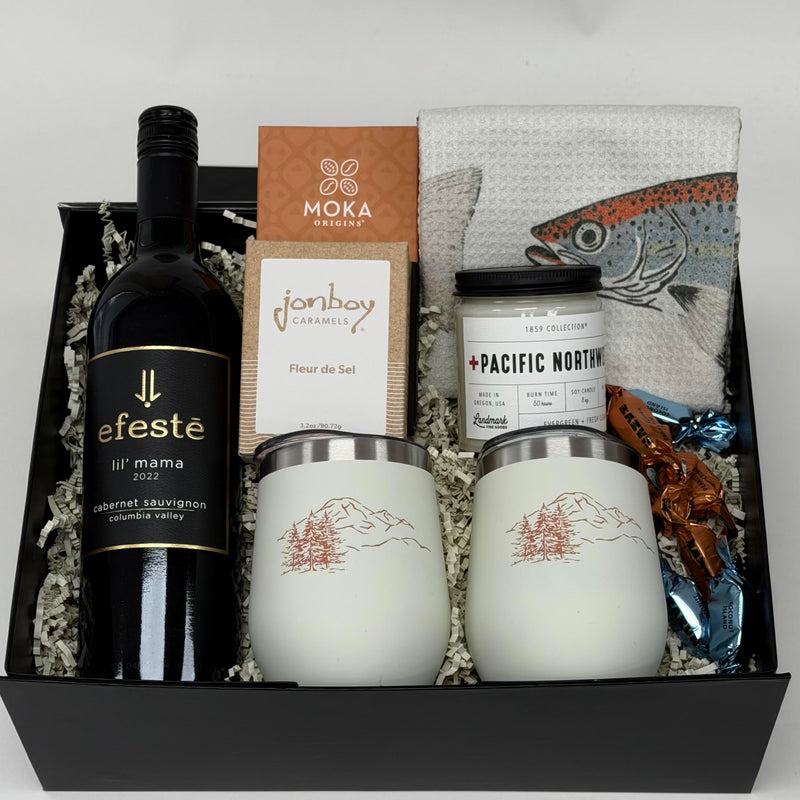 gift box with wine, wine tumblers, tea towel, chocolate, candle and caramel. 
