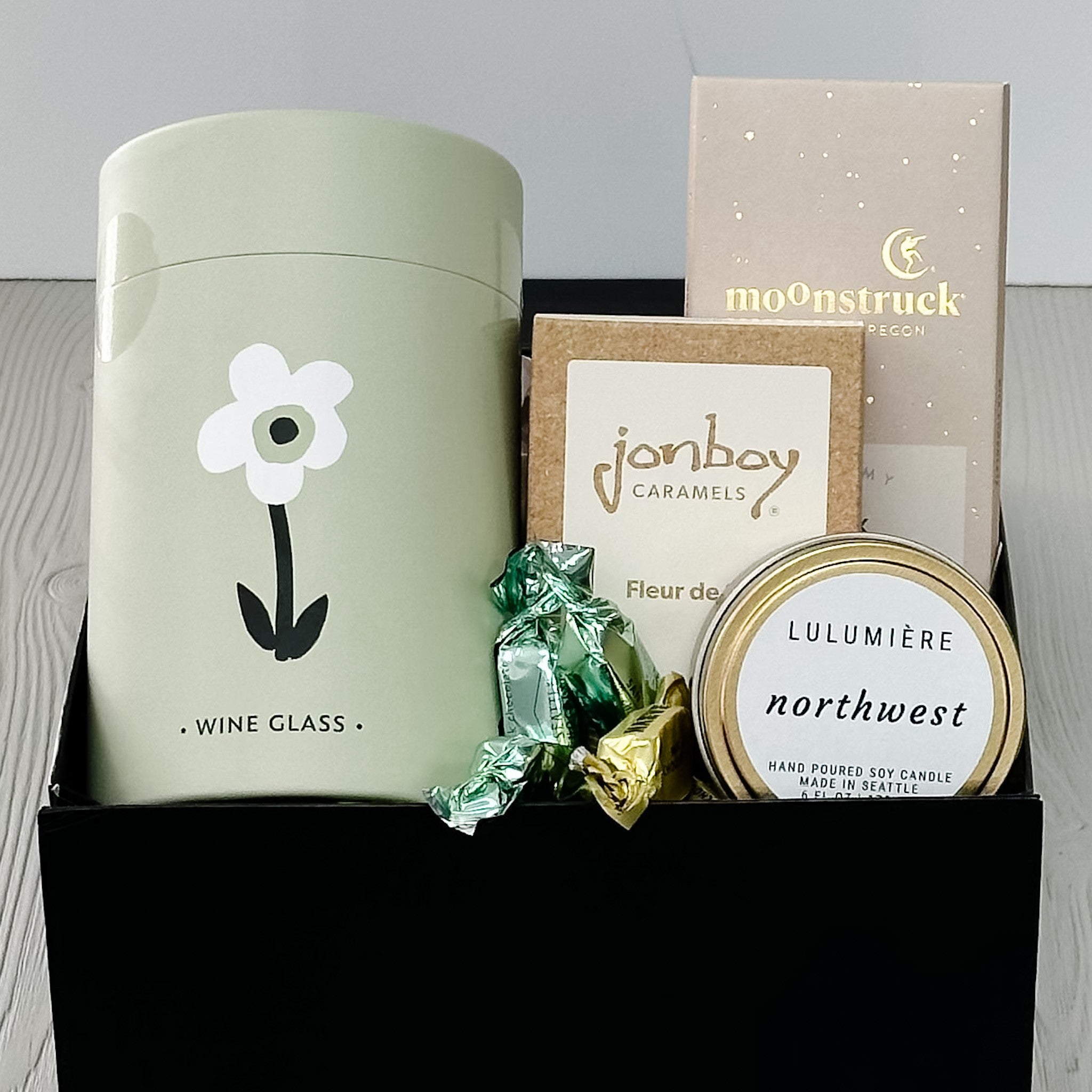 floral wine tumbler, chocolate, caramel, candle included in our petal and pour gift basket.