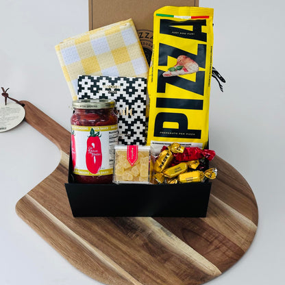 wooden pizza peel, pizza dough, pizza sauce, dish towel, chocolate, pizza knives, candy, bonbons included in our pizza kit gift box.