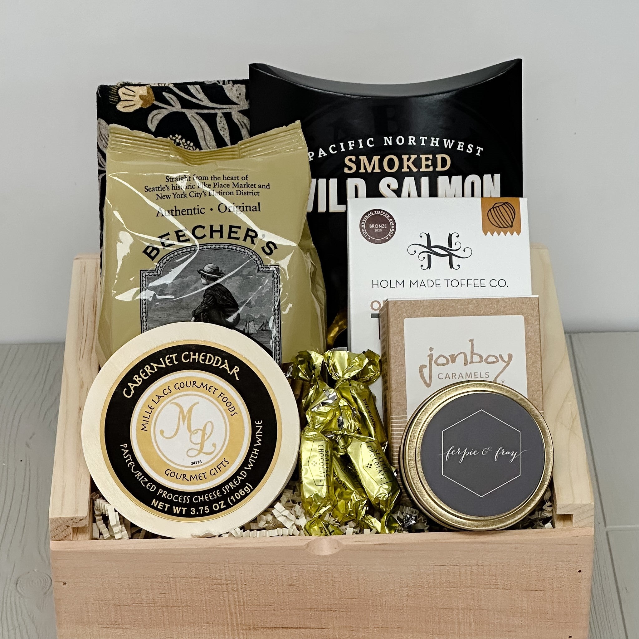 dish towel, smoked salmon, crackers, cheese, toffee, caramel, candle, chocolate all included in our PNW Holiday gift basket