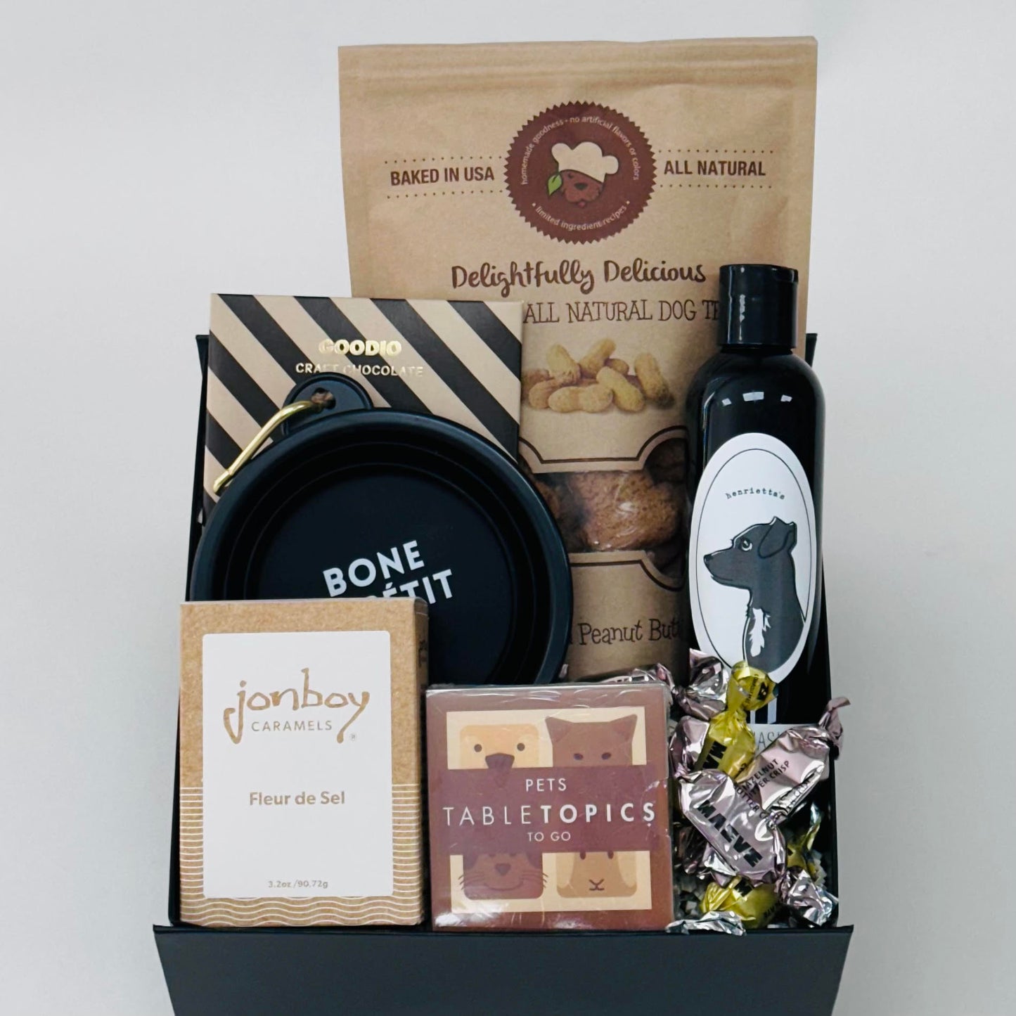 dog biscuits, dog wash, tabletopics, caramel, chocolate, and a dog bowl all included in our puppy love gift box.