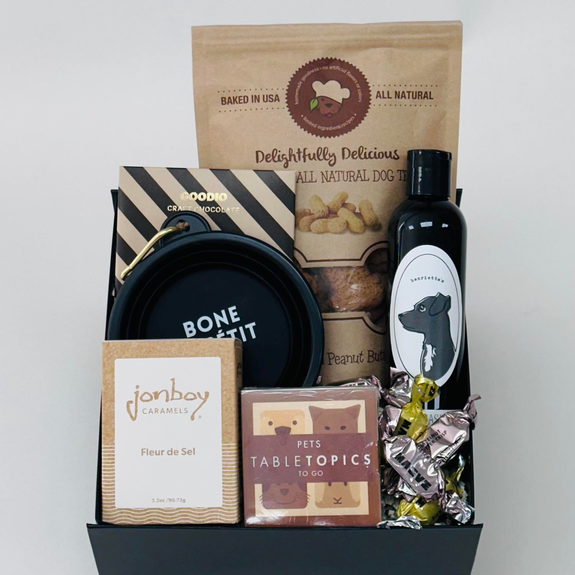 dog biscuits, dog wash, tabletopics, caramel, chocolate, and a dog bowl all included in our puppy love gift box.