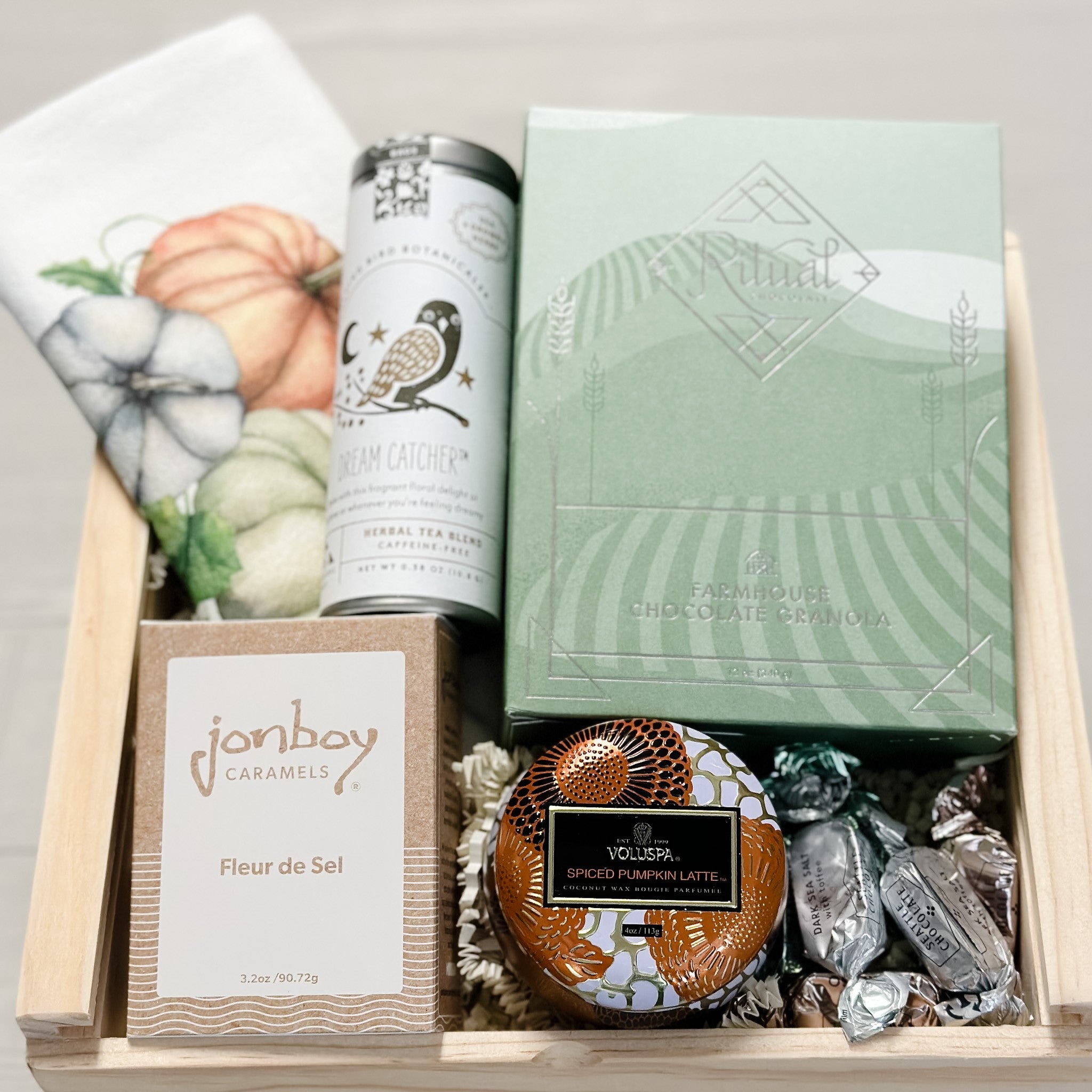 fall breakfast gift basket with granola, tea, scented candle, caramel and dish towel