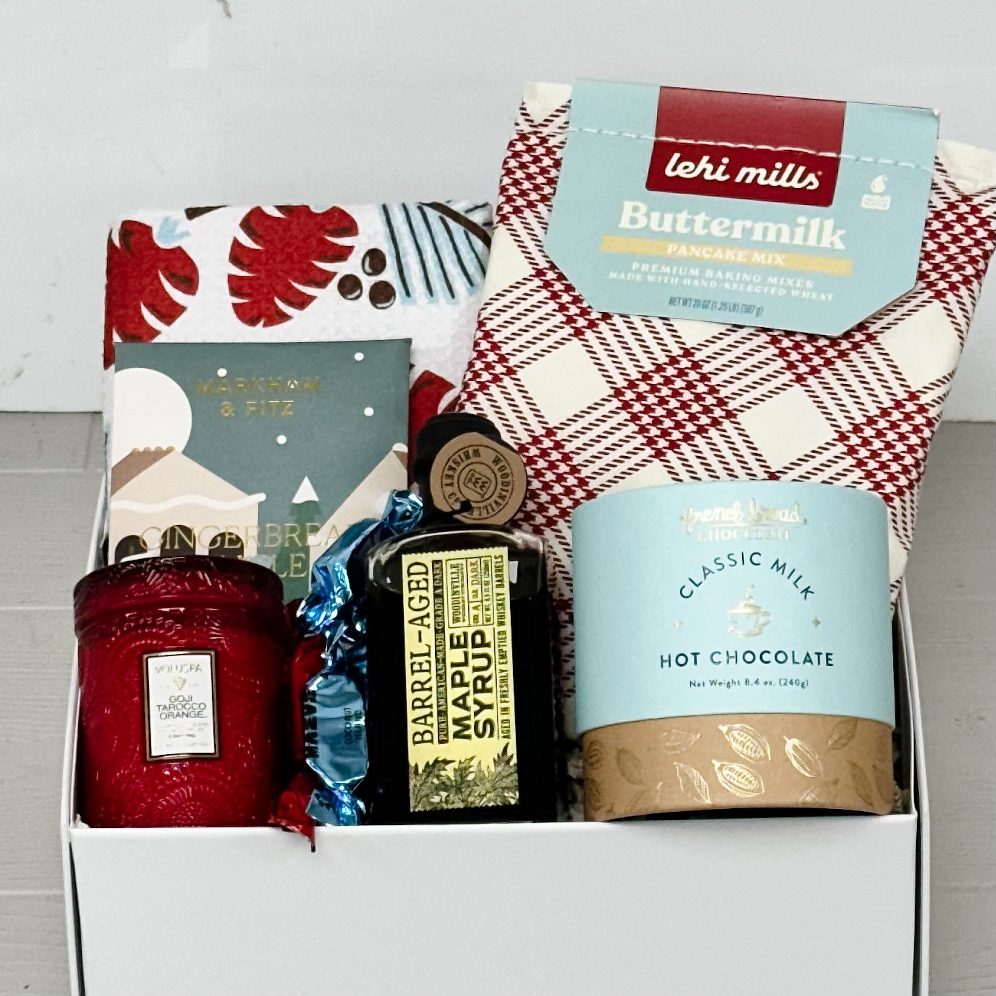 pancake mix, maple syrup, tea towel, chocolate, hot chocolate, and truffles all included in or snowy morning gift basket