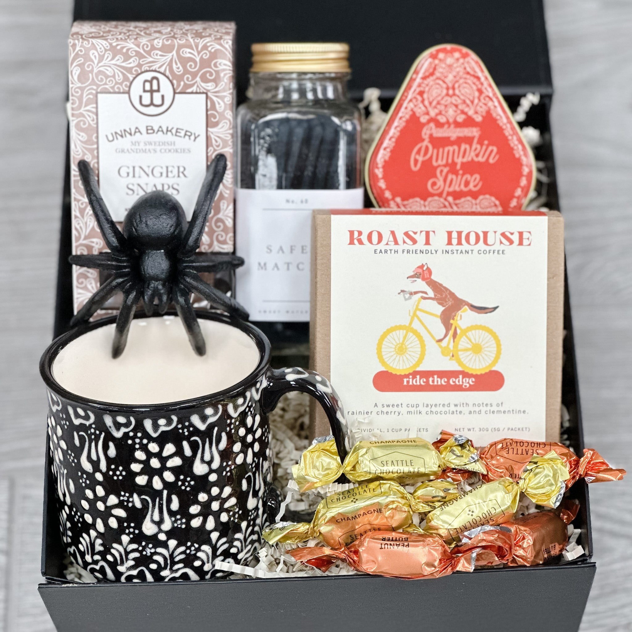 mug, coffee, cookies, candle, matches, truffles, spider all packaged in our spooky sips and sweets gift basket.
