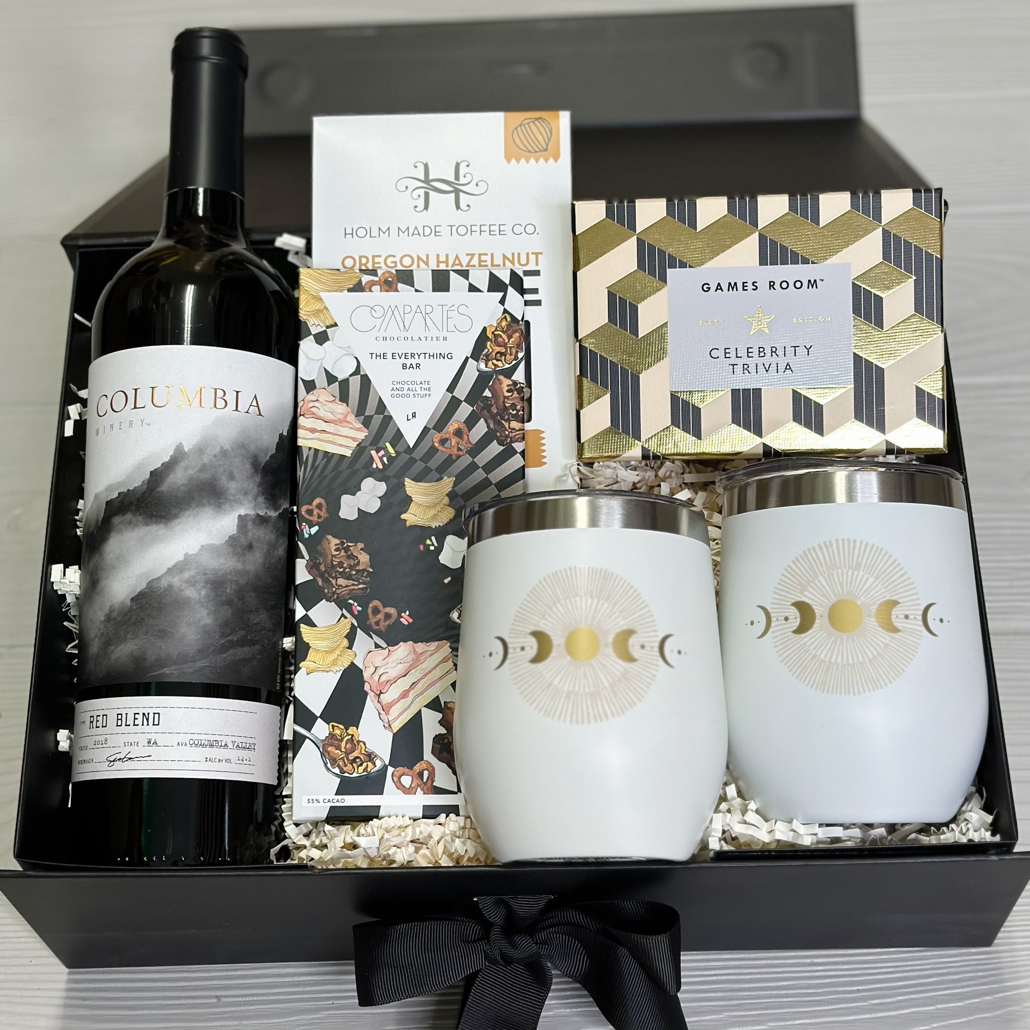 wine, toffee, trivia game, chocolate, 2 wine tumblers included in our happy hour gift basket