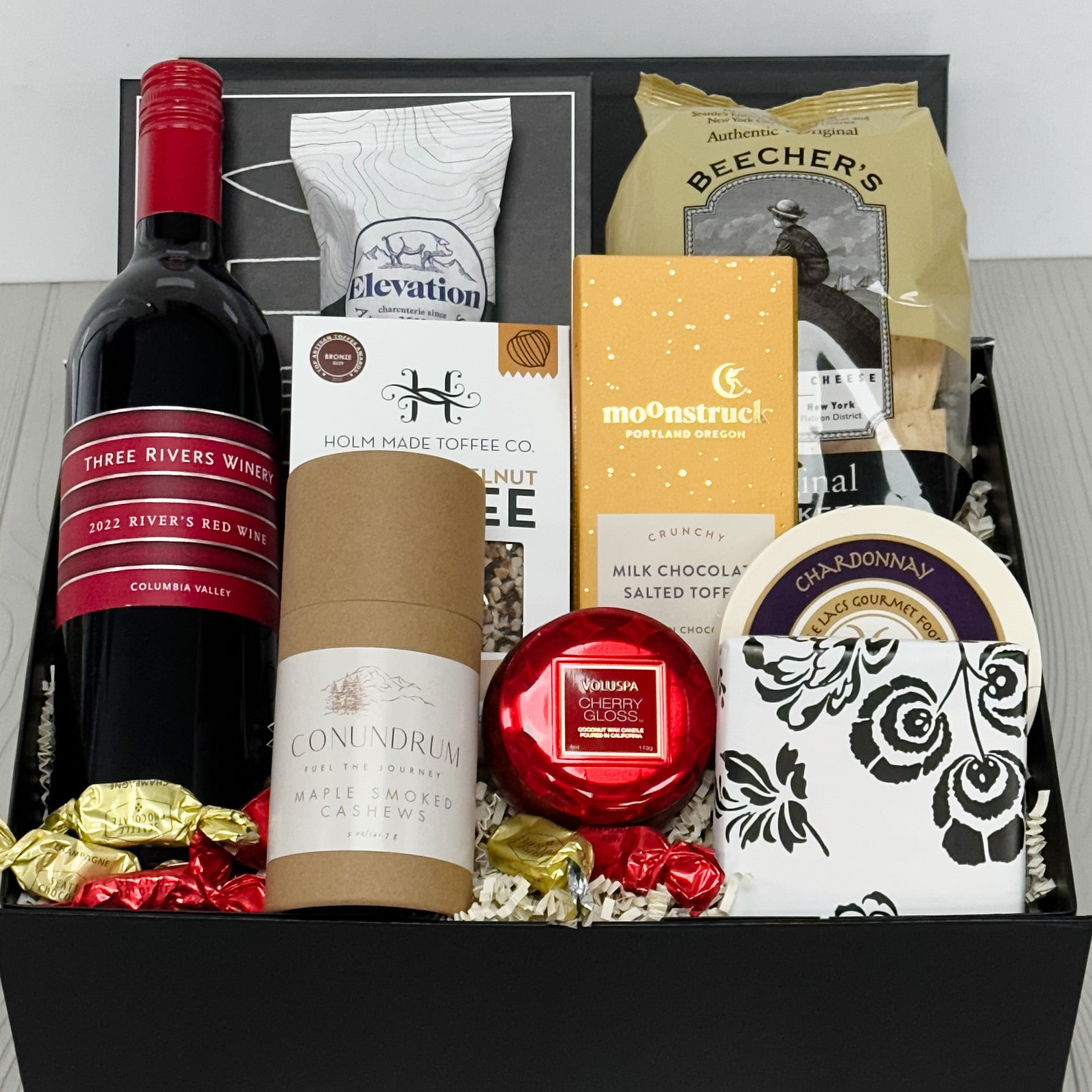 wine, cheese, crackers, chocolate, nuts, cookies and candle all included in our wine & charcuterie gift basket