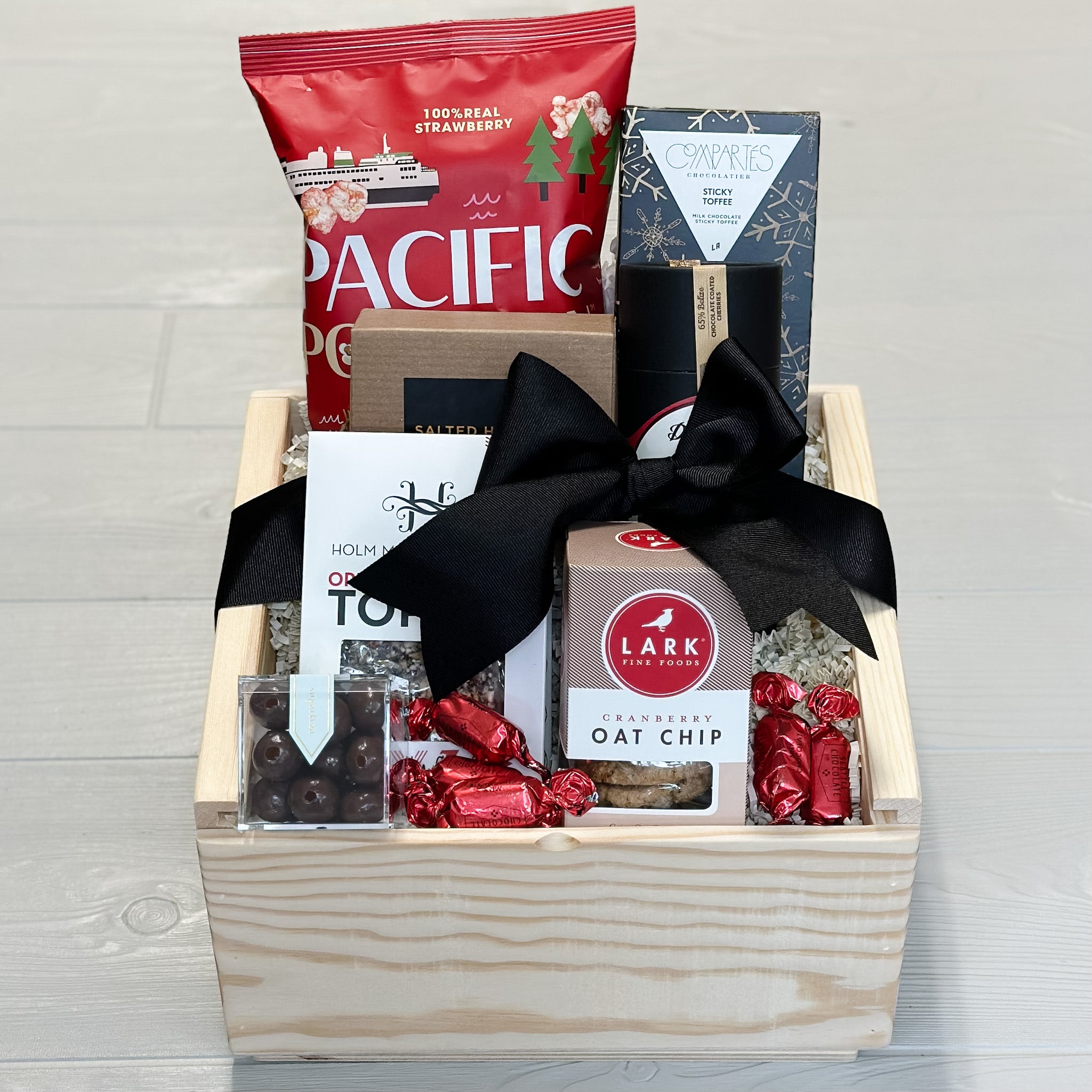 Our Yuletide Snack gift basket includes popcorn, toffee, caramel, cookies, chocolate covered cherries, pretzel balls
